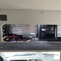 Electrical compartment located above the cab lockable