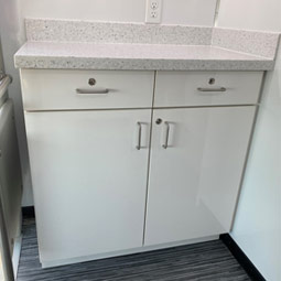 Custom built lockable lower cabinets, 2 lockable drawers with corian countertop