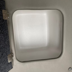 Lockable storage compartment located above the cab
