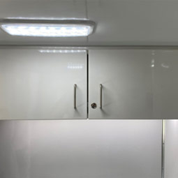 Custom built lockable upper cabinets with LED lighting under